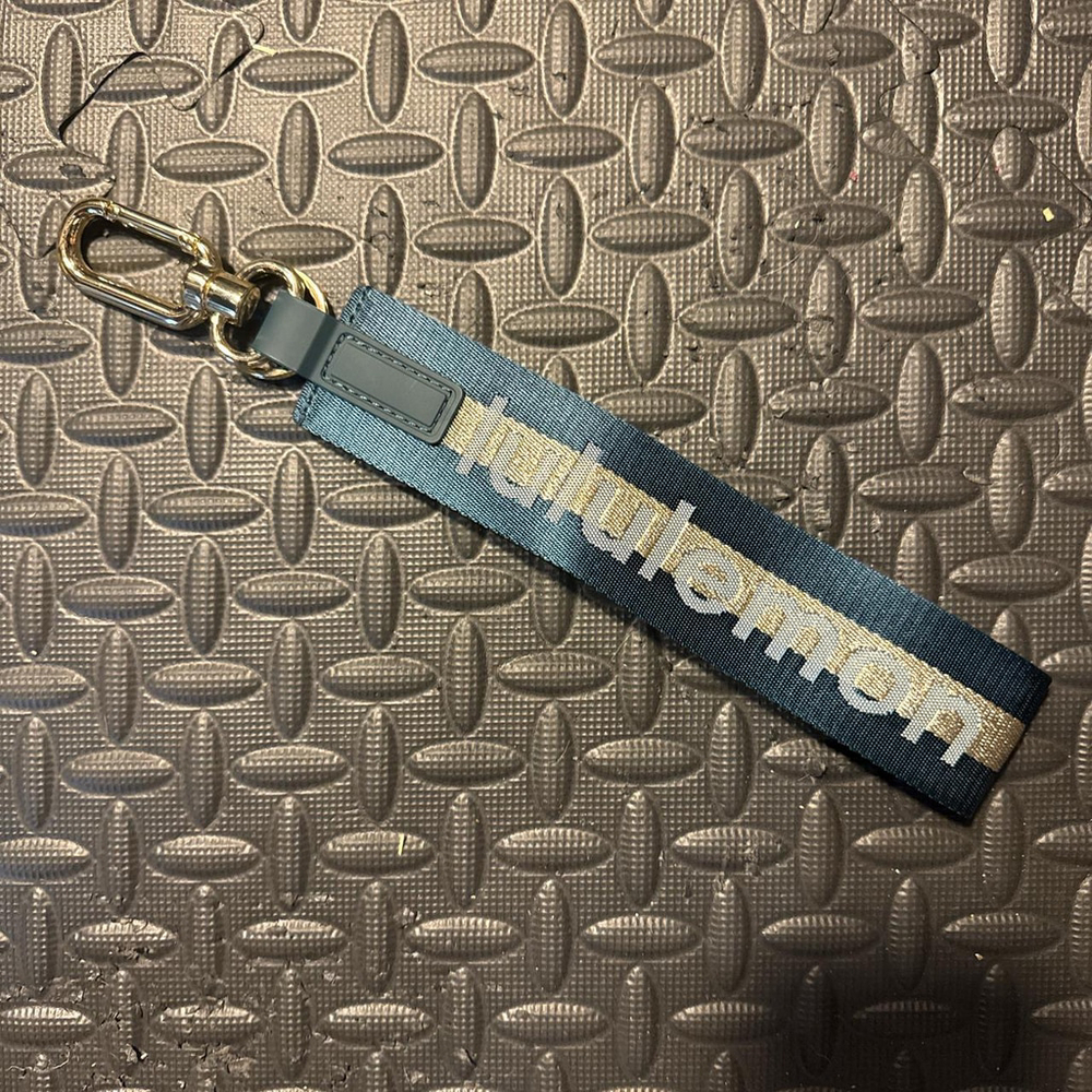 Lululemon teal and gold never lost keychain 

NWOT